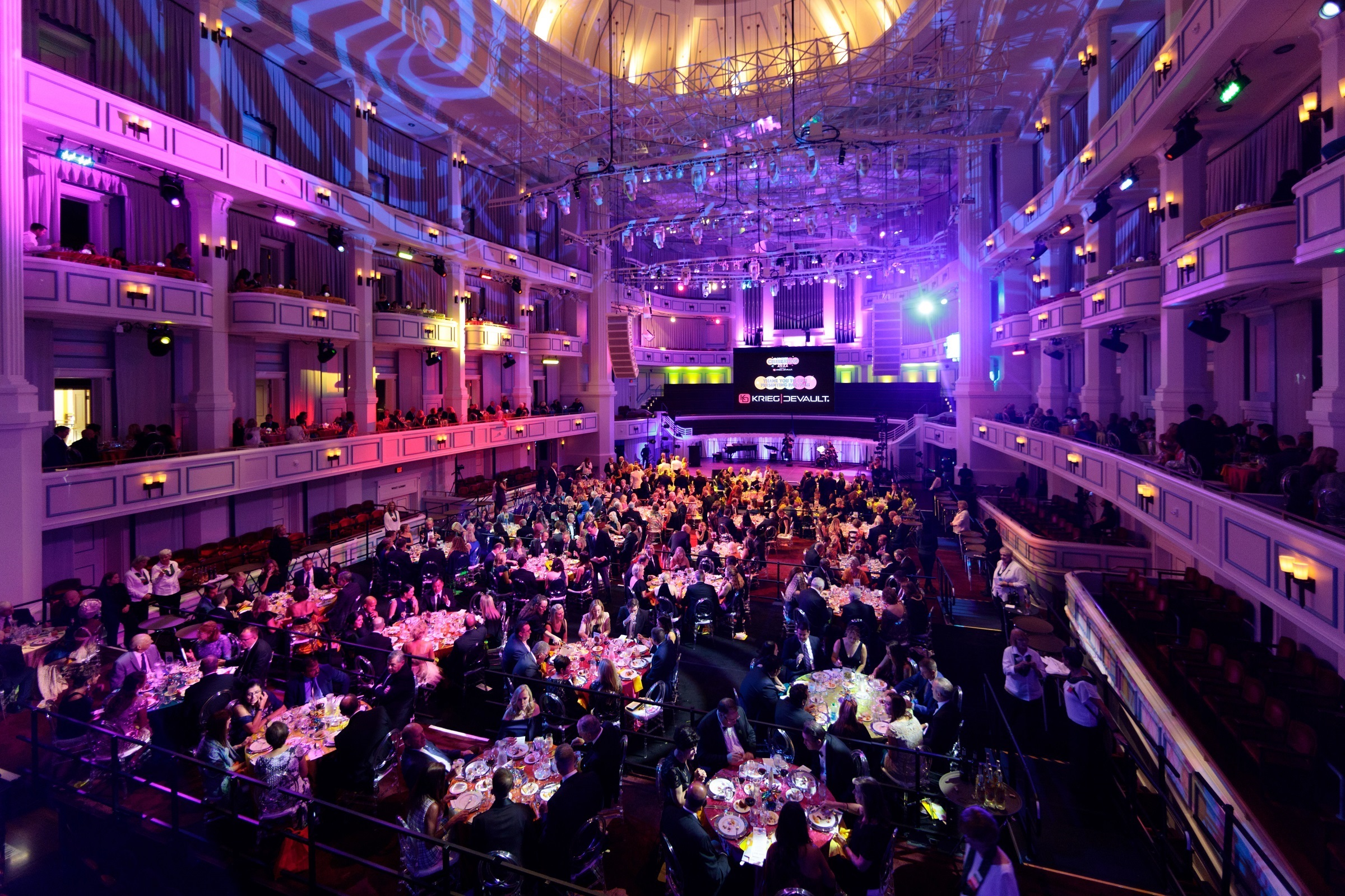 The Palladium concert hall is bathed in blue and purple light as guests dine at tables during Center Celebration 2022.