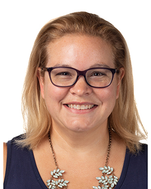 Headshot of a woman with long blonde hair and dark glasses