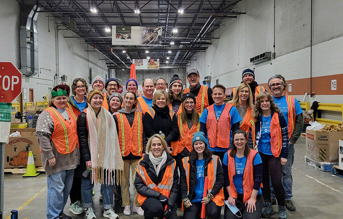 More than 20 people pose for a photo at at the Gleaners Food Bank warehouse.