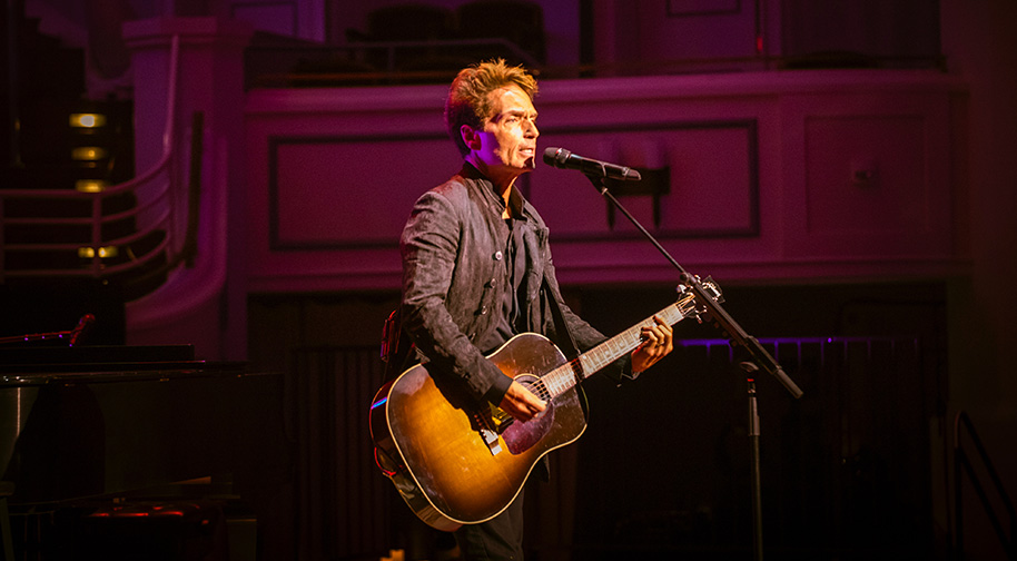 Richard Marx plays guitar during his headlining performance.