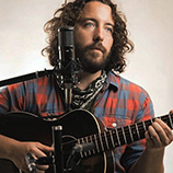 Singer-songwriter Jeff Kelly plays an acoustic guitar