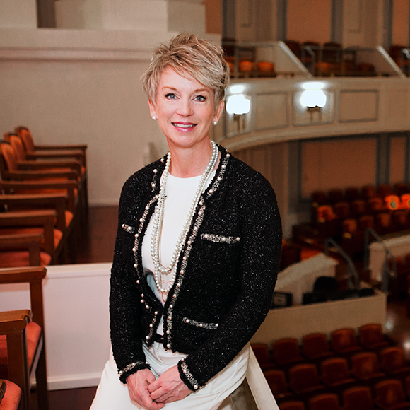 Vice President of Development Kendra Latta sits in the Palladium concert hall.