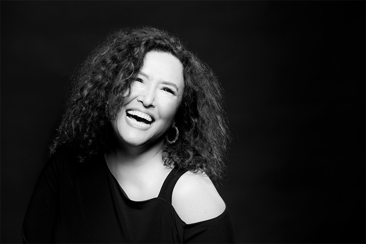 Singer-songwriter Melissa Manchester smiles in a black and white image.