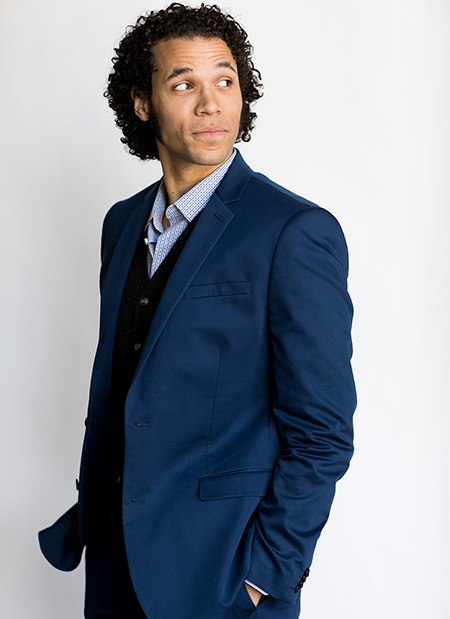 Singer-actor Jordan Donica poses in a blue suit against a white background.