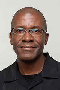 Man with glasses wearing black shirt