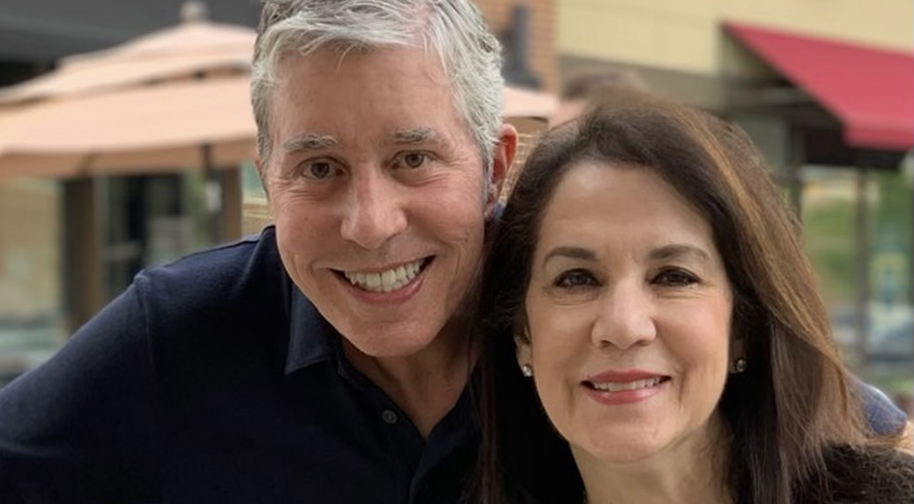 A man and woman smile for a photo.