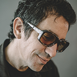 Portrait of singer-songwriter A.J. Croce wearing dark glasses