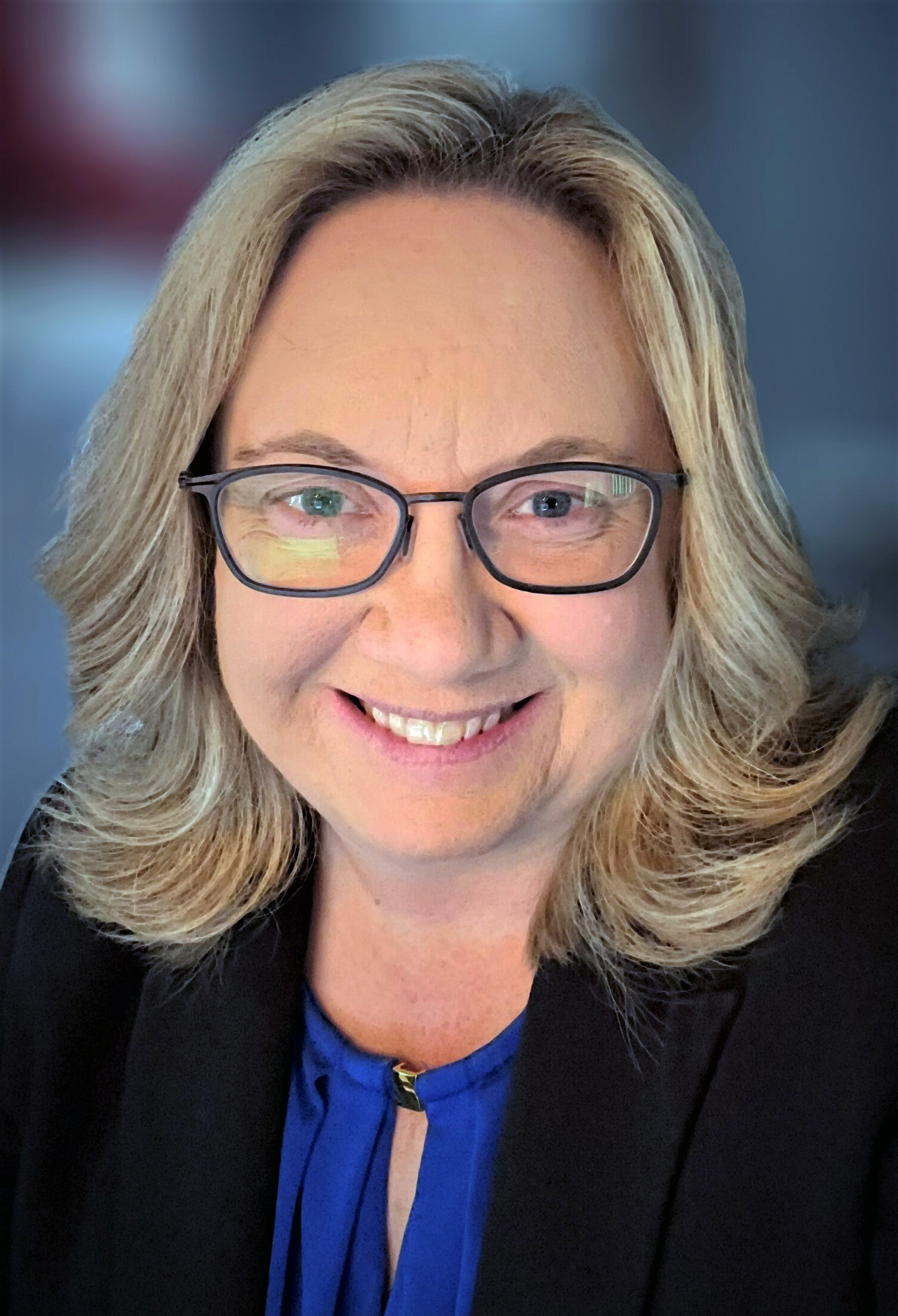 A woman with blonde hair and eyeglasses