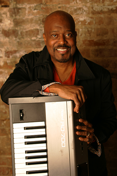 Musician Kenny Brawner poses with a digital keyboard.