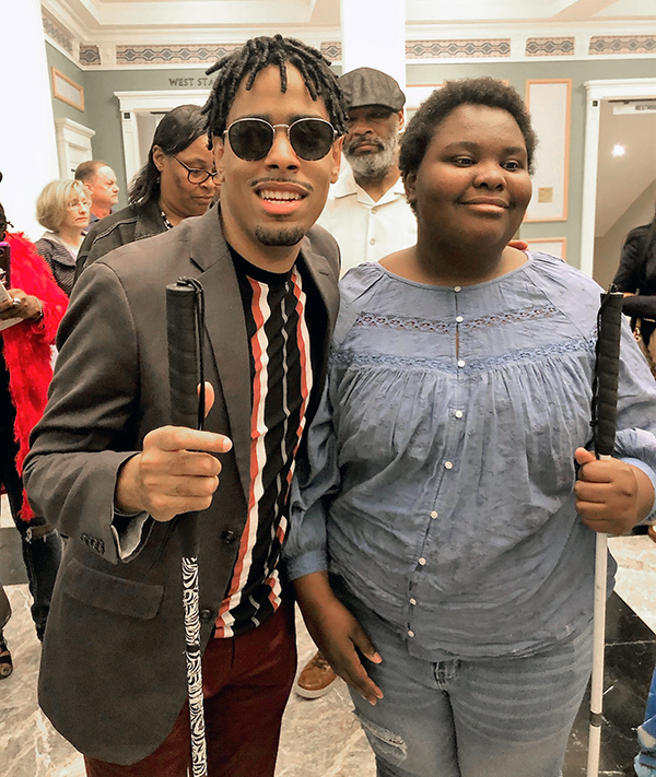 A young man and woman pose for a photo.