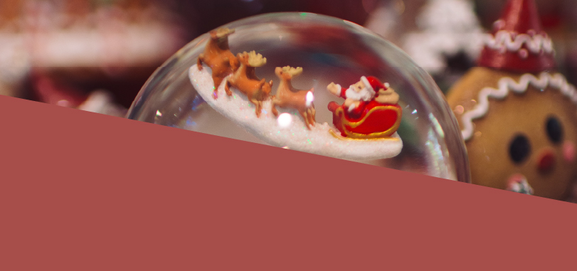 A snow globe with Santa and flying reindeer.