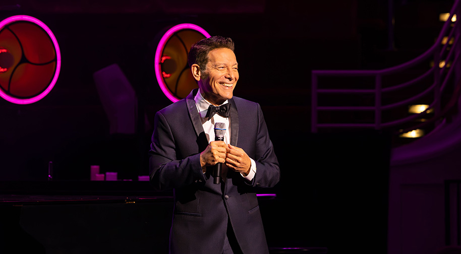 Michael Feinstein wears a tuxedo a smiles as he greets the audience at the Center Celebration.