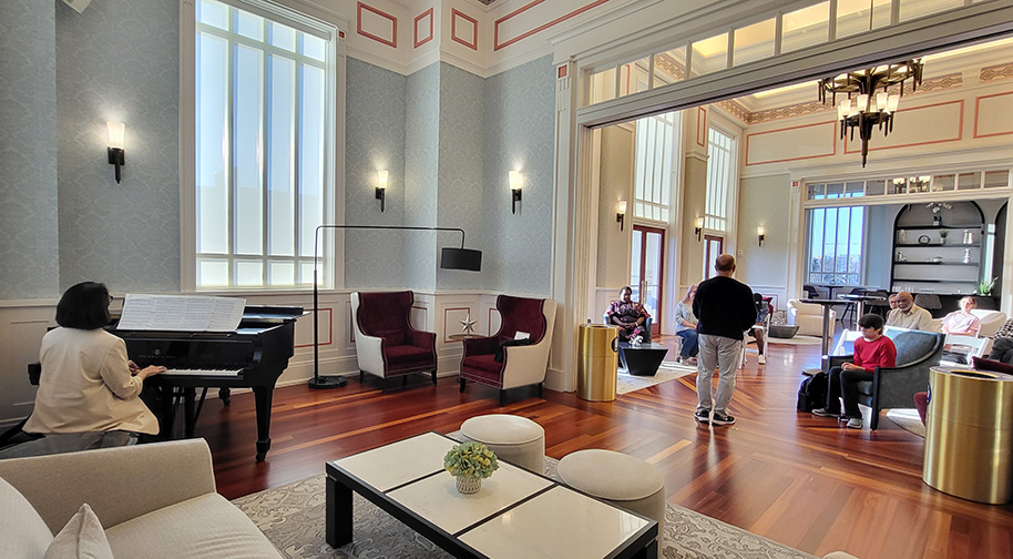 A teacher in the Group Vocal Coaching class sings with piano accompaniment.
