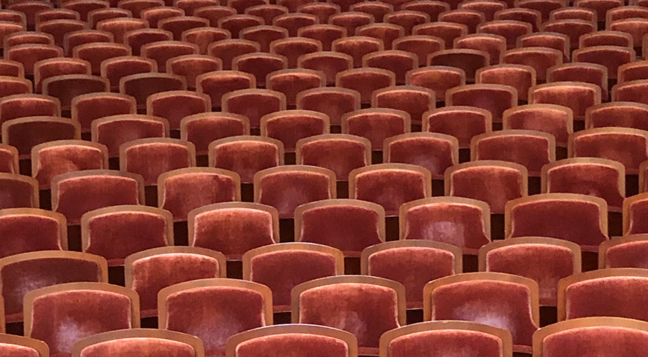 Plush red seats in the Payne & Mencias Palladium