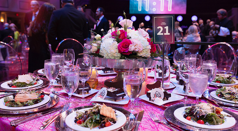 An elegant dinner with a floral centerpiece.